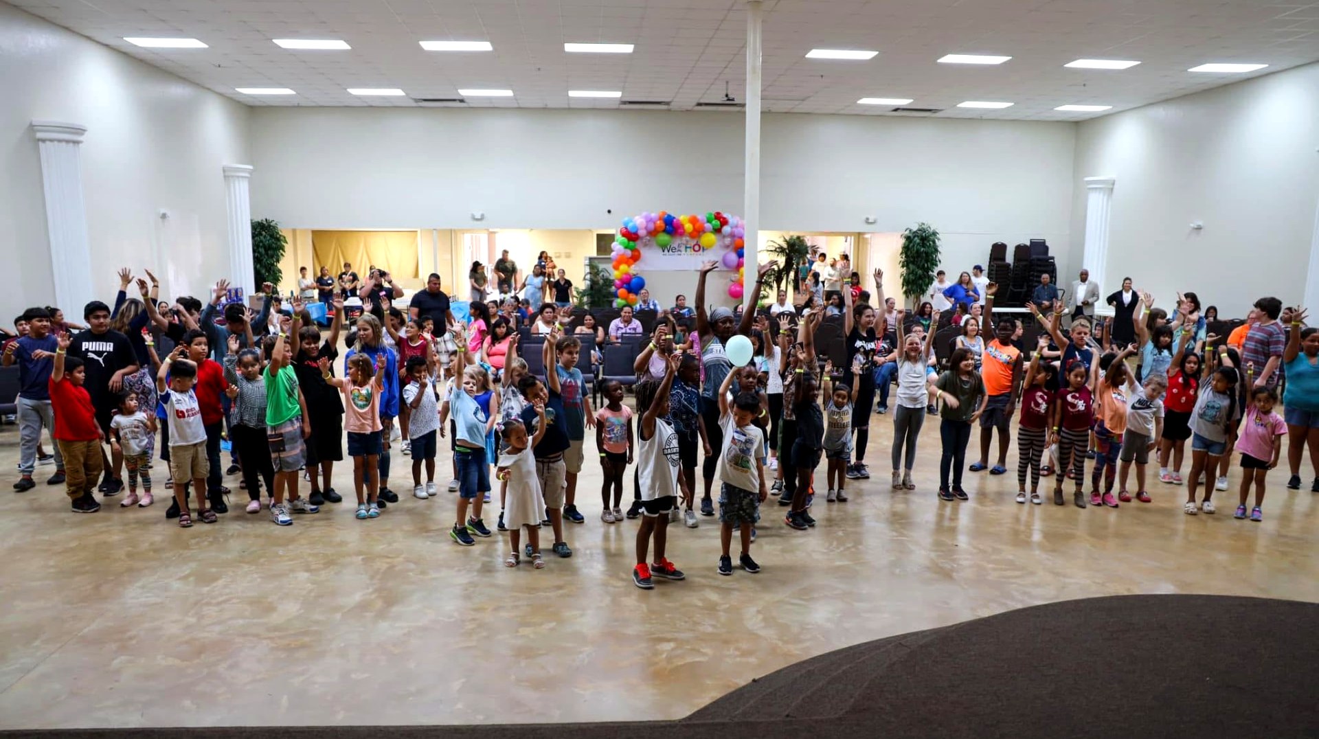 Young people and volunteers gathered together at a WeHOP community event
